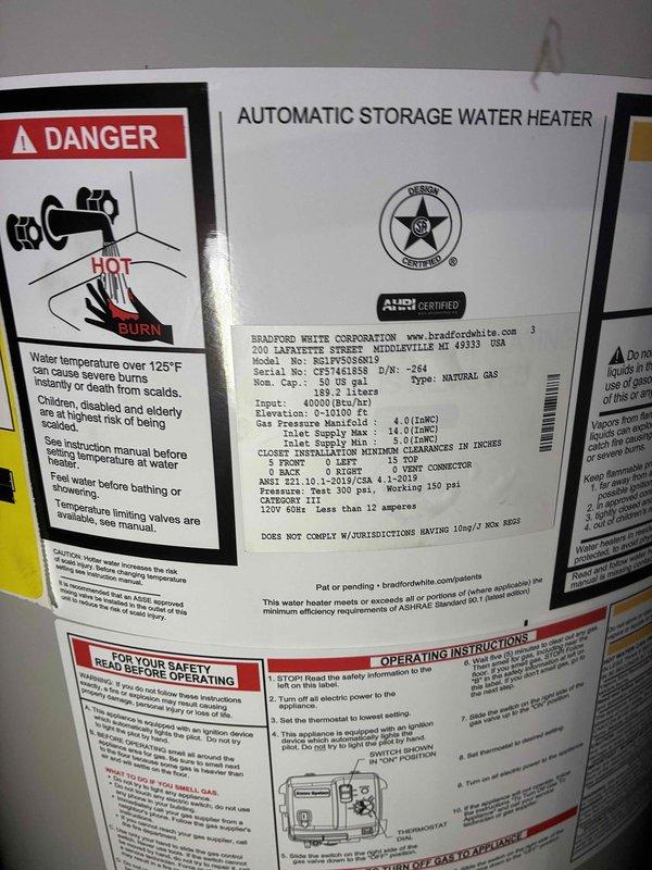 Completed full installation of Bradford White automatic storage water heater in mechanical room, including all necessary gas piping connections, water supply lines, and proper venting. Replaced existing condensate pump to ensure proper drainage from HVAC system. All equipment tested and verified operational per manufacturer specifications, with safety labels and operating instructions clearly visible on installed unit.