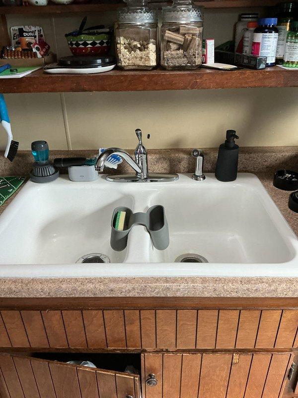 Completed comprehensive plumbing fixture replacement and shutoff valve upgrades throughout the residence. In the kitchen, removed and replaced the existing faucet with a new chrome single-handle unit with side sprayer, installed new angle stops at both hot and cold supply lines, and rebuilt the basket strainer assembly with new tubular drain components. In the bathroom, replaced the lavatory faucet with a new two-handle chrome fixture, installed fresh angle stops for both water supplies, and replaced all P-trap and tailpiece drain components. At the water heater location, removed the old gate-style shutoff valve and installed a new quarter-turn ball valve for improved reliability and ease of operation. Additionally, installed a new main water shutoff valve on the house side of the water service for emergency isolation capability. All connections tested and verified leak-free with proper water flow and drainage confirmed at all fixtures.