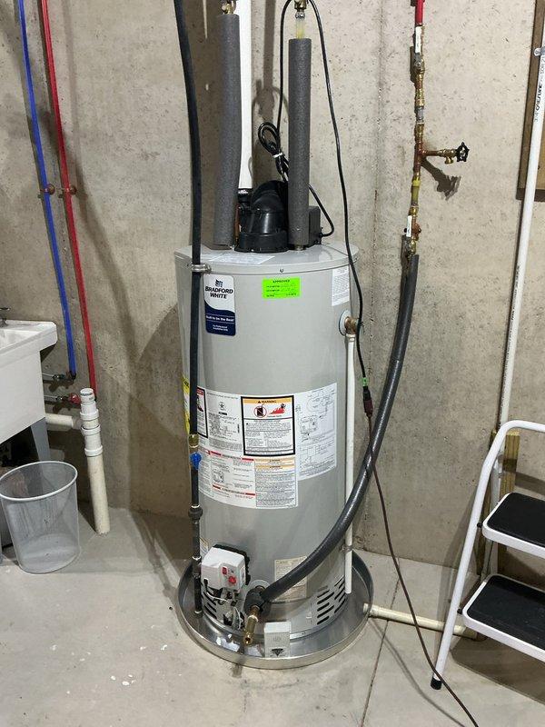 Responded to water heater issue where residence had hot water in only half of the home. Upon arrival, inspected 3-year-old Bradford White heat pump water heater model WT 10-2033. Diagnosed and resolved circulation problem affecting hot water distribution throughout the home. Verified all plumbing connections, tested heat pump compressor operation, and confirmed proper function of inlet and outlet valves. System restored to full operation with hot water now available to entire residence.