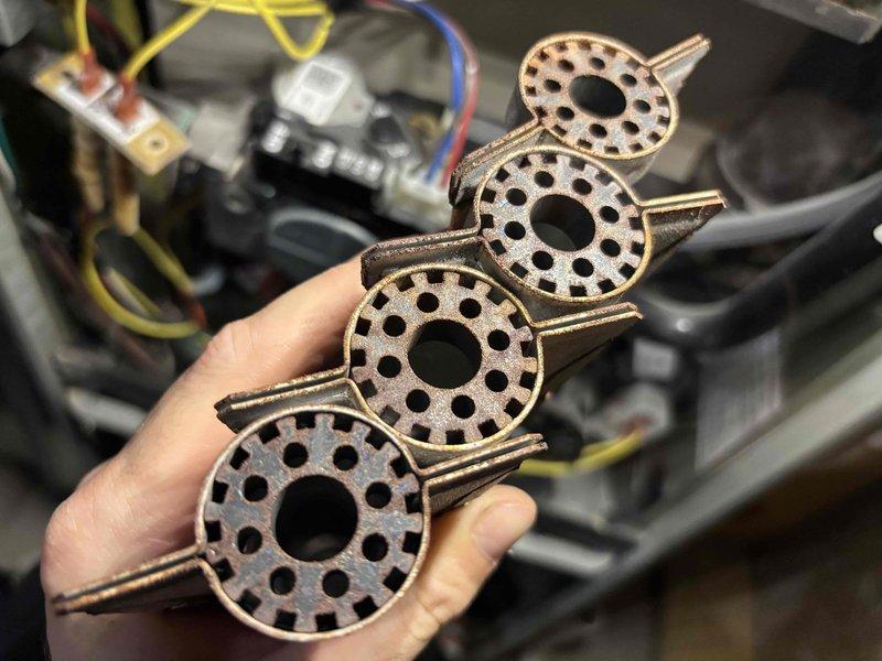 # No Heat Service Call

Responded to a no-heat service call on a 7-year-old furnace experiencing ignition failure. Upon inspection, discovered the flame sensor assembly required cleaning due to carbon buildup and oxidation preventing proper flame detection. Removed and cleaned four flame sensor components, which featured perforated disc designs with central openings and radial hole patterns. These sensors are critical for confirming ignition and maintaining safe furnace operation.

After cleaning the sensors and reinstalling them into the burner assembly, tested the furnace through multiple heating cycles to verify proper ignition sequence and flame detection. System ignited successfully and maintained consistent operation. Verified all safety controls were functioning correctly, including the flame rollout switches and limit controls.

Inspected the burner assembly, heat exchanger, and venting system for any signs of damage, corrosion, or blockages. All components appeared in good con