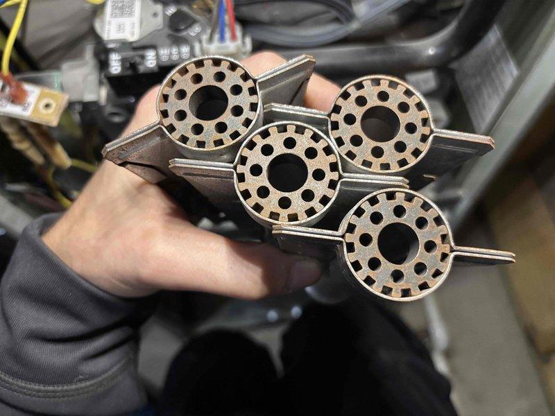 # No Heat Service Call

Responded to a no-heat service call on a 7-year-old furnace experiencing ignition failure. Upon inspection, discovered the flame sensor assembly required cleaning due to carbon buildup and oxidation preventing proper flame detection. Removed and cleaned four flame sensor components, which featured perforated disc designs with central openings and radial hole patterns. These sensors are critical for confirming ignition and maintaining safe furnace operation.

After cleaning the sensors and reinstalling them into the burner assembly, tested the furnace through multiple heating cycles to verify proper ignition sequence and flame detection. System ignited successfully and maintained consistent operation. Verified all safety controls were functioning correctly, including the flame rollout switches and limit controls.

Inspected the burner assembly, heat exchanger, and venting system for any signs of damage, corrosion, or blockages. All components appeared in good con