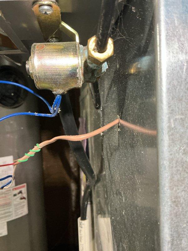 Completed annual heating maintenance on 9-year-old Nordyne furnace and humidifier system. Performed comprehensive tune-up including inspection of electrical connections, gas valve solenoid, and ductwork-mounted safety sensors. Documented equipment condition with photos showing humidifier solenoid valve assembly and attic-mounted overflow safety switch on HVAC ductwork. All components operating within normal parameters; system ready for heating season.