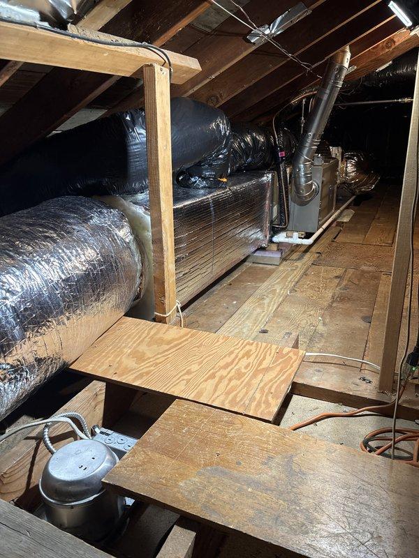 Completed full HVAC system installation including outdoor condensing unit, attic-mounted air handler with ductwork, furnace, and water heater. Installed new refrigerant lines with insulation, electrical conduit and connections, PVC condensate drain piping, and positioned equipment on concrete pad and attic platform per code requirements. All components tested and operational upon completion.