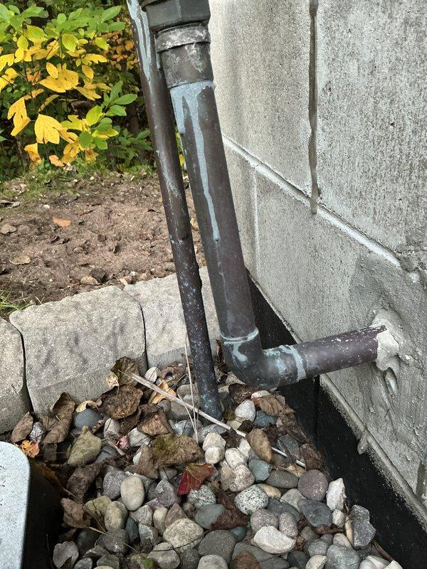 Conducted comprehensive site assessment for exterior spigot installation. Evaluated existing plumbing infrastructure including interior copper supply lines with shutoff valve access through ceiling cavity and exterior drainage system along foundation. Documented current pipe routing, identified optimal connection points for new hose bib installation, and assessed structural considerations for wall penetration through concrete block exterior. Photographed interior water supply configuration and exterior mounting location near landscaped drainage area to develop accurate material list and installation plan for customer approval.