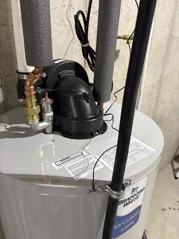 Completed installation of electric anode rod on Bradford White water heater as quoted repair with partial warranty coverage. Unit inspected, existing anode rod removed, and new electric anode rod installed with proper electrical connections verified and secured. All plumbing connections, pressure relief valve, and top assembly components checked for proper operation following installation.