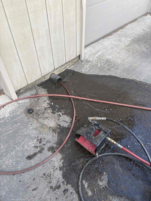 Performed comprehensive sewer line jetting and camera inspection services at residential property. High-pressure water jetting equipment was deployed to clear blockages and buildup from the underground drainage system, followed by detailed video camera inspection to assess line condition and verify successful cleaning. Documentation captured includes ground-level cleanout access point and diagnostic equipment setup during the 4-5 hour service operation.