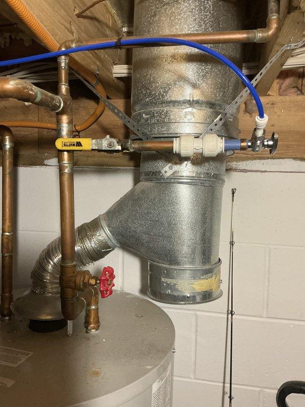 Provided estimate for replacement of existing Bradford White water heater in residential basement mechanical room. Assessed current installation including copper supply lines, galvanized ductwork connections, expansion tank with blue flexible connector, and associated plumbing components with brass fittings and shutoff valves. Documented existing configuration and presented replacement options to customer.