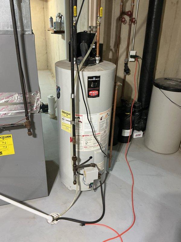 Provided estimate for tankless water heater system replacement to replace existing conventional tank-style water heater in residential basement utility room. Assessed current installation including plumbing connections, electrical requirements, venting configuration, and available space for new tankless unit installation.