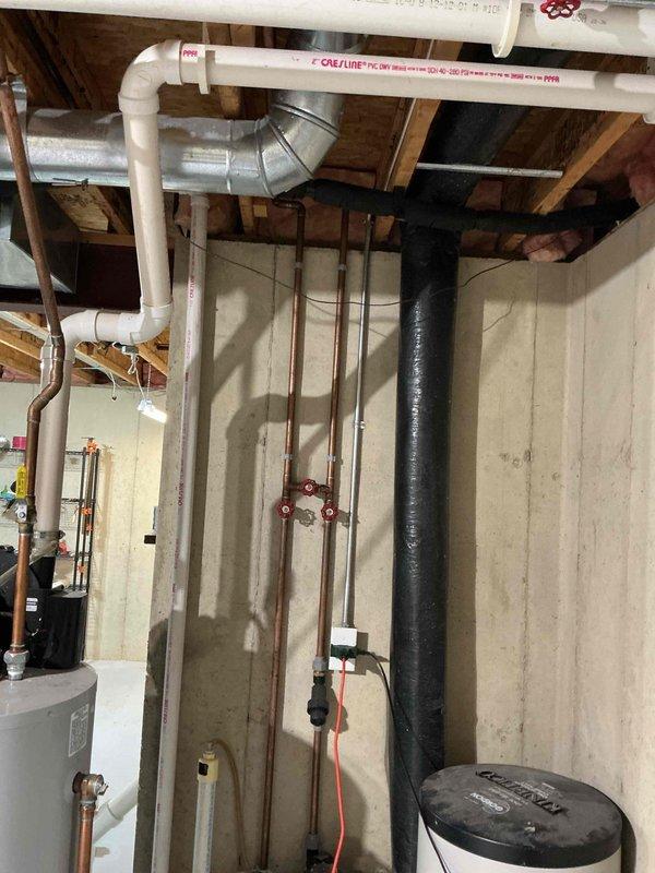 Provided estimate for tankless water heater system replacement to replace existing conventional tank-style water heater in residential basement utility room. Assessed current installation including plumbing connections, electrical requirements, venting configuration, and available space for new tankless unit installation.