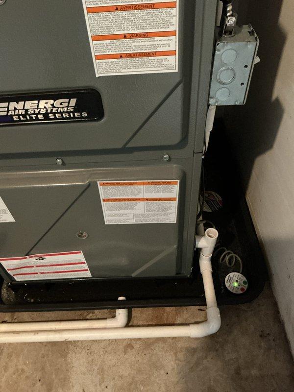 Completed annual heating maintenance on 9-year-old Energi Air Systems Elite Series furnace. Performed comprehensive system inspection including visual examination of all electrical connections, capacitors, and control board components. Verified proper operation of blower motor assembly, checked all wire connections for security and signs of wear, and inspected condensate drainage system with white PVC piping for proper function. All warning labels present and legible. Unit operating within normal parameters with no immediate concerns identified. Documentation photos captured for service records.