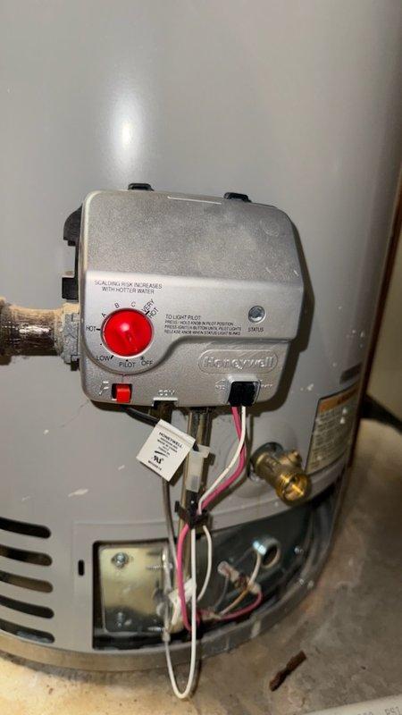 Responded to service call for 13-year-old tank water heater with pilot light that would not remain lit. Upon inspection, diagnosed failed Honeywell gas control valve assembly. Replaced defective gas control valve with new unit, reconnected thermocouple and gas supply lines, and tested system for proper ignition and flame retention. Verified water heater returned to normal operation with stable pilot light and burner function.