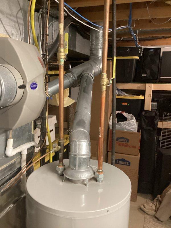 Responded to service call for 13-year-old tank water heater with pilot light that would not remain lit. Upon inspection, diagnosed failed Honeywell gas control valve assembly. Replaced defective gas control valve with new unit, reconnected thermocouple and gas supply lines, and tested system for proper ignition and flame retention. Verified water heater returned to normal operation with stable pilot light and burner function.