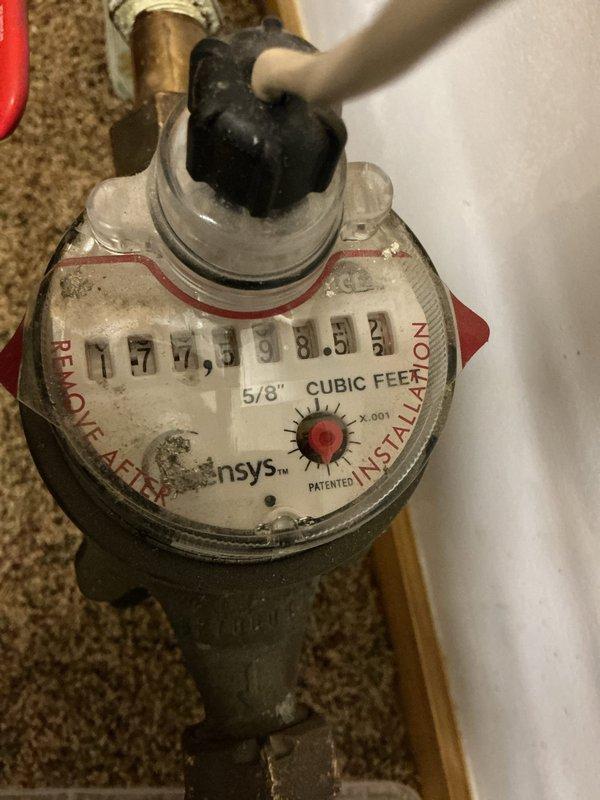Responded to low water pressure complaint following recent water heater installation. Upon inspection, identified undersized 5/8" water meter as primary cause of reduced flow throughout residence. Meter restriction was limiting system capacity and creating pressure drop affecting all fixtures. Documented existing Lochinvar water heater installation with copper supply lines and expansion tank configuration. Recommended meter upgrade to 3/4" or larger to restore adequate water pressure and flow rate for household demand.