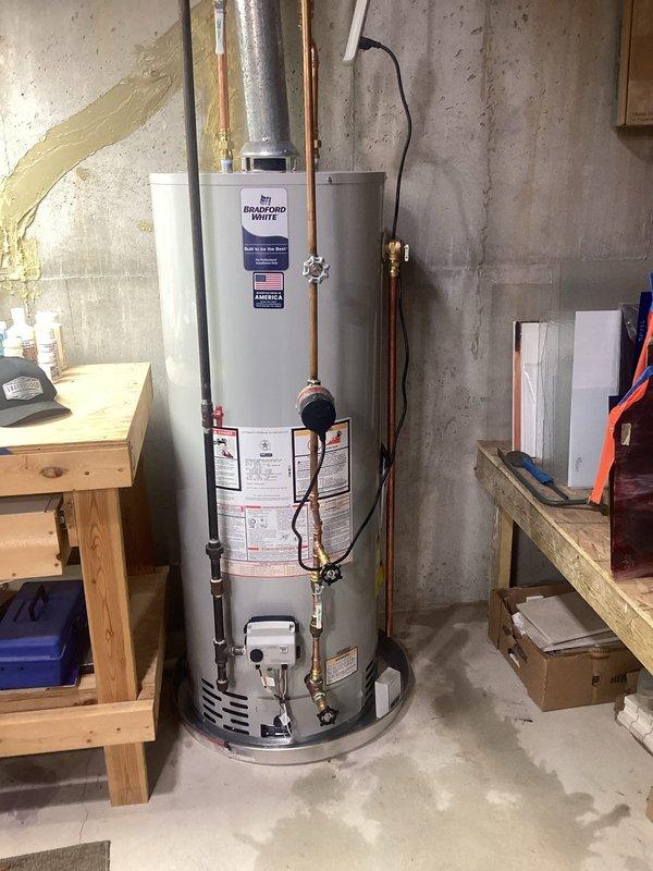 Installed a Bradford White 50-gallon natural gas water heater (Model RG250T6N) with 40,000 BTU input rating in basement utility area. Completed all required piping connections, gas line hookup, exhaust venting, and electrical connections per manufacturer specifications and local code requirements, ensuring proper clearances and operational safety standards were met.