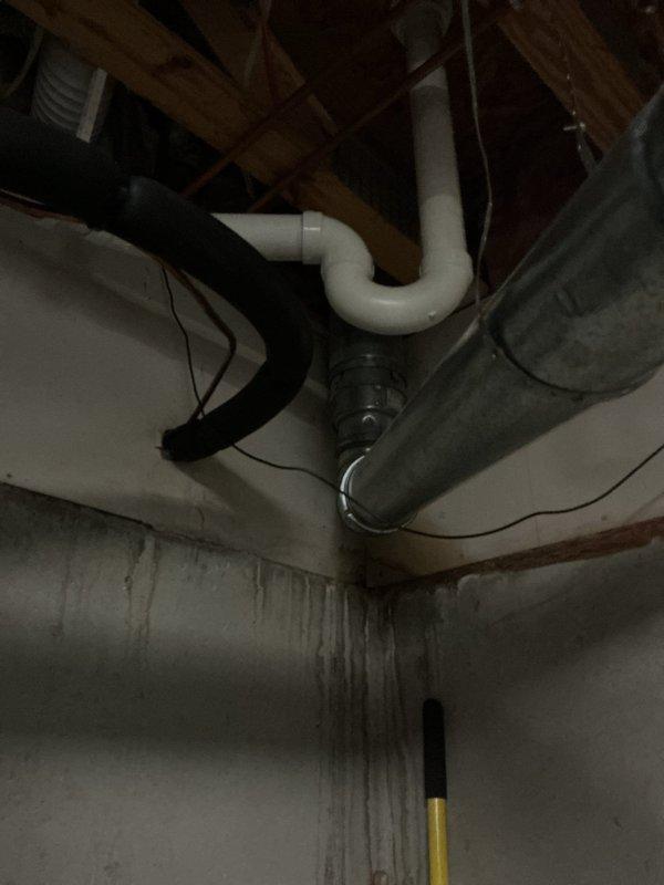 Responded to service call for water heater system with reported super low pressure and no visible water leaks after initial HVAC diagnostic attempt. Performed comprehensive inspection of water heater, expansion tank, and associated plumbing connections in mechanical room. Examined all supply lines, pressure relief valve, shut-off valves, and piping throughout the system including basement crawl space areas. Inspected expansion tank mounting and connections, verified proper installation of temperature and pressure relief valve with discharge piping. Assessed all copper supply lines, galvanized piping, and PVC drainage systems for potential pressure loss points. Documented equipment configuration including insulated water heater tank, wall-mounted expansion tank, and connection points to HVAC system. Investigated crawl space plumbing for hidden leaks or restrictions that could cause pressure issues. Photographed installation for service records showing mechanical room layout and undersid