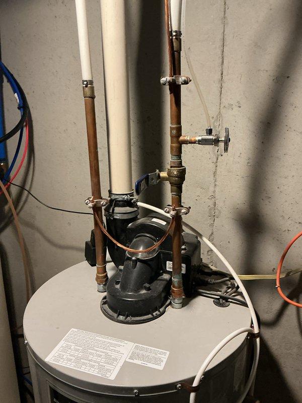Responded to a reported tank leak on a 14-year-old Bradford White power-vent water heater and inspected the unit, including the blower and vent assembly, PVC exhaust piping, copper supply lines, shutoff valves, and drain piping. The tank and connections showed no visible rust, frost, or active leaking at the time of inspection, and all fittings appeared intact. Same-day emergency service was unavailable, so the customer was placed on the priority schedule for expedited follow-up.