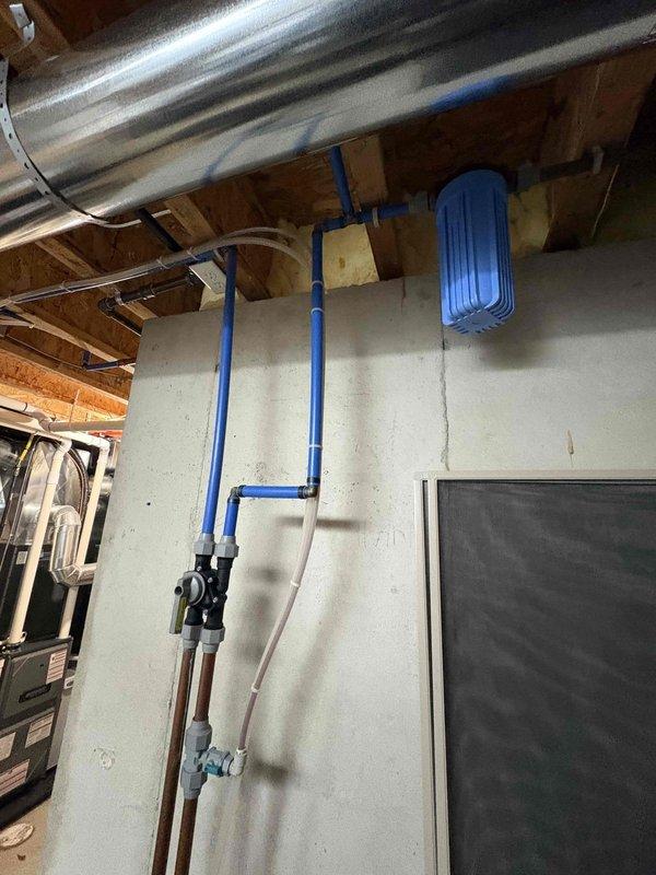 Installed a new whole-house water softener with a digital control valve head, connected to the existing supply plumbing with PEX and brass fittings, and mounted a sediment filter housing on the wall upstream of the system. Verified all connections for leaks, programmed the control valve, and confirmed proper operation of the softener, filter, and expansion tank with no visible damage to surrounding plumbing.