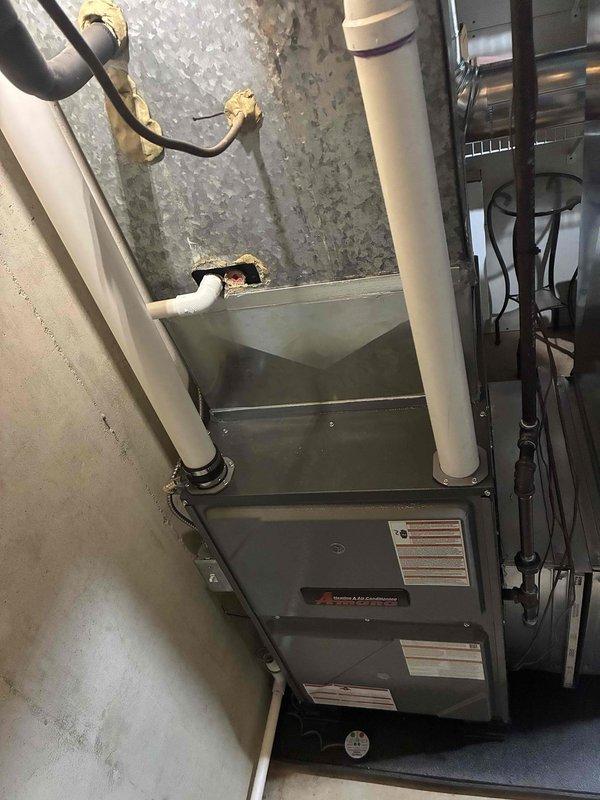 Installed a new Amana gas furnace in the utility space, connecting the PVC combustion/exhaust and condensate drain piping, gas supply line with shutoff valve, and electrical and control wiring. Sealed and tied the unit into the existing galvanized supply plenum and ductwork, and verified the existing Aprilaire whole-house humidifier and humidistat remained properly connected and in good condition.