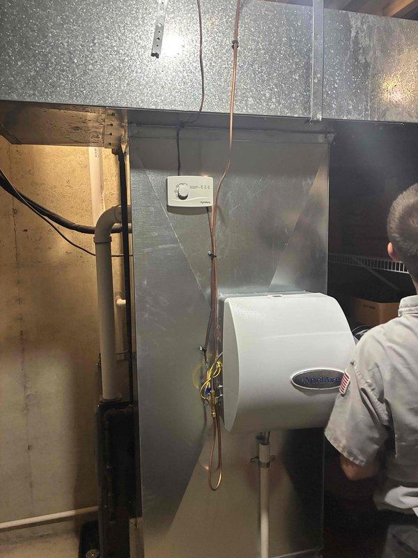 Installed a new Amana gas furnace in the utility space, connecting the PVC combustion/exhaust and condensate drain piping, gas supply line with shutoff valve, and electrical and control wiring. Sealed and tied the unit into the existing galvanized supply plenum and ductwork, and verified the existing Aprilaire whole-house humidifier and humidistat remained properly connected and in good condition.
