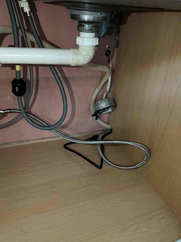 Installed and connected a dishwasher and refrigerator water supply, routing braided stainless steel supply lines and drain connections under the kitchen sink cabinet. Installed a Sterling 1.0 cu ft. digital meter water softener with control head, brine tank, and associated valve fittings and drain tubing in the basement utility area. Completed all connections and verified the system was properly installed with no visible leaks.