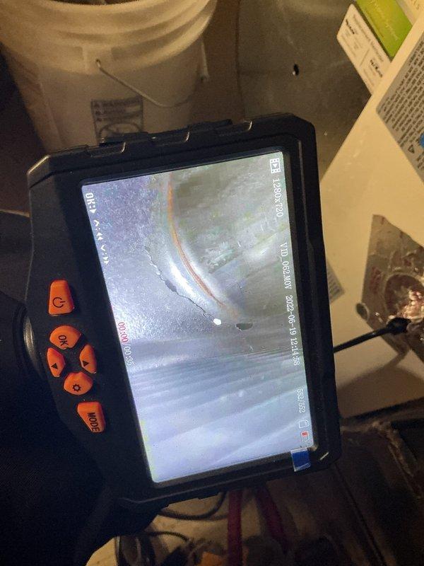 Performed annual heating inspection on a 16-year-old furnace, including borescope examination of the heat exchanger. Imaging revealed a perforation with an associated hairline crack and rust streaking along the seam, indicating heat exchanger failure. Documented findings with photos and recommended heat exchanger or furnace replacement, as continued operation poses a carbon monoxide safety risk.