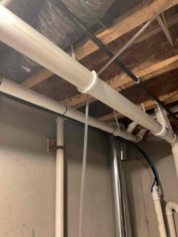 Installed a new 50-gallon LP power vent water heater, completing the water, gas, and venting connections and placing the unit in a drain pan with a leak sensor. Routed and secured the PVC vent/intake piping and condensate drain to the exterior, then verified proper operation and leak-free connections.