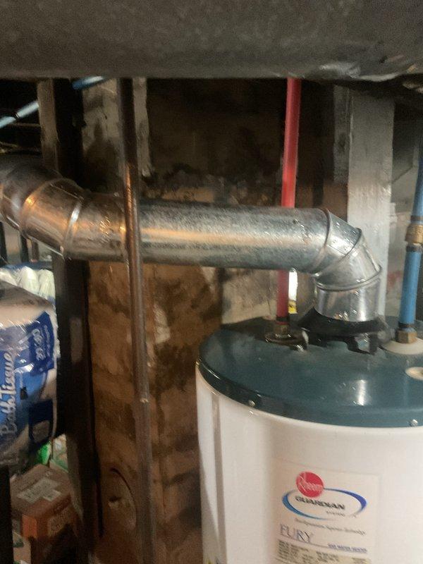 Responded to a Rheem Guardian gas water heater reported as not heating and leaking, and inspected the unit, including the flue connection, inlet and outlet water connections with shutoff valve, and tank fittings. Diagnosed the loss of heating and leak condition and performed the necessary repairs to restore operation. Verified proper venting and connections, confirmed the unit was heating and holding without leaks, and left it operating normally.