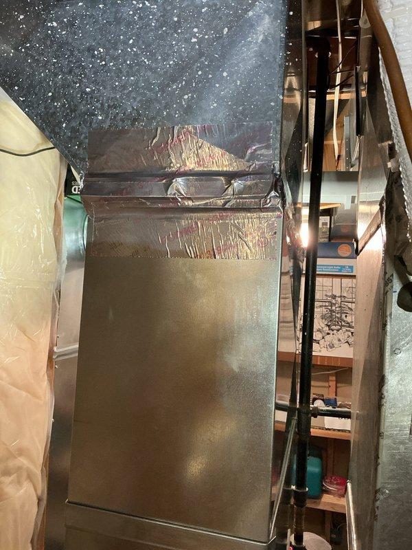 Repaired a separated ductwork seam near the furnace by realigning the duct sections and sealing the joint with foil-faced HVAC tape to restore a secure, airtight connection at the transition fitting. Inspected adjacent duct connections and fasteners for additional leaks or loosening and confirmed the repair was stable and properly sealed.