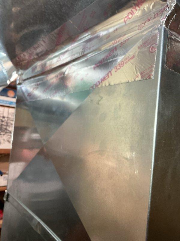 Repaired a separated ductwork seam near the furnace by realigning the duct sections and sealing the joint with foil-faced HVAC tape to restore a secure, airtight connection at the transition fitting. Inspected adjacent duct connections and fasteners for additional leaks or loosening and confirmed the repair was stable and properly sealed.