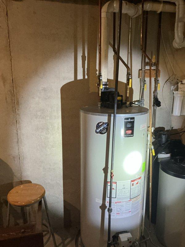 Performed an on-site estimate for replacement of an approximately 12-year-old gas-fired power-vent water heater. Inspected the unit, its PVC power-vent assembly, gas supply and control valve, and copper supply lines with isolation ball valves, and documented existing conditions with photographs. Observed no visible leaks, corrosion, or damage to the tank or piping, and assessed the installation for replacement scope and options.