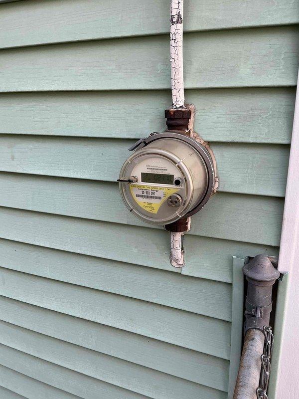 Performed an on-site estimate for replacement of an approximately 24-year-old outside AC condensing unit at a 900 sq ft single-family home; no operational symptoms, damage, or urgency were reported. Documented the exterior electric meter and conduit, noting heavily cracked and peeling paint on the conduit, and photographed the interior electrical load center (breaker panel) to assess the electrical supply serving the system. Estimate options were reviewed for the homeowner, who is currently gathering quotes.