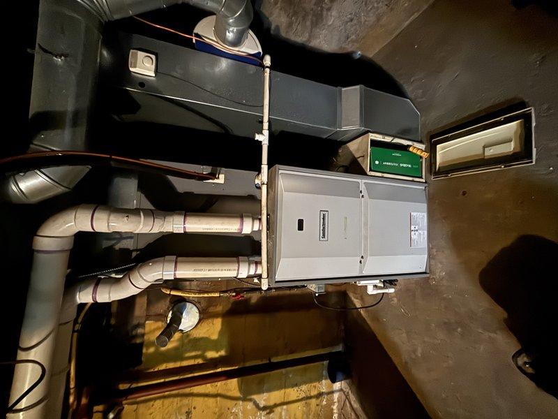 Performed a Furnace Super Tune-up on a gas-fired forced-air furnace, including inspection of the burner assembly, heat exchanger, venting, condensate drain, and ductwork connections, with a visual check of the unit's data plate and brand information. Identified heavy corrosion and pitting on the heat exchanger surfaces, including a localized area of possible perforation, which presents a combustion safety concern and should be evaluated further and addressed before continued operation.