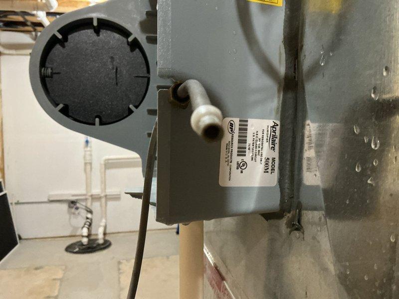 Performed a complete tune-up on a Carrier Infinity gas furnace, including inspection of the burner assembly, venting, gas connections, and electrical components, with the system operating normally and showing no signs of rust, frost, or damage. Inspected the Aprilaire 500M humidifier and noted heavy condensation on the adjacent supply duct. Equipment is in good working condition, with the furnace covered under a 6-year service plan.