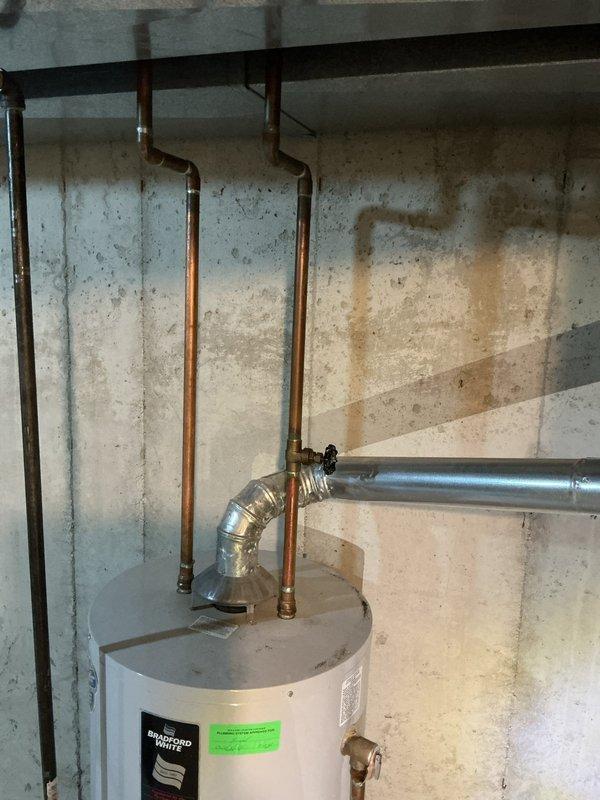Performed an on-site evaluation and furnace replacement estimate for a non-operational Lennox gas furnace in a confined mechanical closet, documenting the existing venting, ductwork, refrigerant line, and electrical connections to scope the changeout. Also assessed a 30-year-old Bradford White atmospheric-vent gas water heater reported to be leaking from the top of the tank, and prepared a bundled replacement quote for both units.