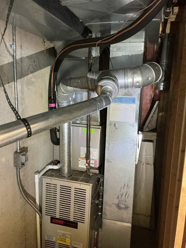 Performed an on-site evaluation and furnace replacement estimate for a non-operational Lennox gas furnace in a confined mechanical closet, documenting the existing venting, ductwork, refrigerant line, and electrical connections to scope the changeout. Also assessed a 30-year-old Bradford White atmospheric-vent gas water heater reported to be leaking from the top of the tank, and prepared a bundled replacement quote for both units.