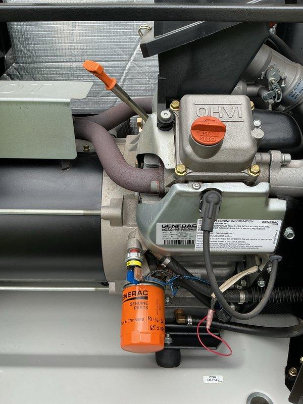 Performed scheduled annual maintenance on an 11-year-old Generac standby generator with an OHVI engine, including inspection of the enclosure, engine compartment, battery, and control panel. Replaced the Generac Genuine Parts oil filter and serviced the engine oil, noting the service date on the filter. All components were found clean with no evidence of leaks, rust, frost, or damage, and the unit was left in proper standby condition.