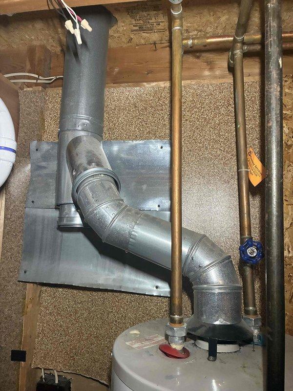 Performed an on-site estimate for a 19-year-old water heater reported to be leaking from the top, inspecting the tank top, hot and cold water supply connections, shut-off valve, and flue venting assembly. Observed water-spotting and mild residue on the flue elbow sections, and the unit's age indicates it has exceeded its typical service life, so replacement is recommended and the estimate was documented with photos.