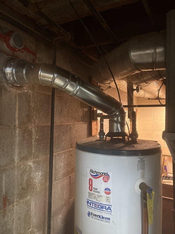 Installed a new Energi Elite Series gas furnace in the basement utility area on a drain pan, connecting the supply and return ductwork, plenum, gas line, and PVC intake/exhaust venting. Verified the furnace is level and secured, labeled the return air filter size (16x24x1 or 16x25x1), and confirmed the adjacent water heater flue remains properly routed and undisturbed.