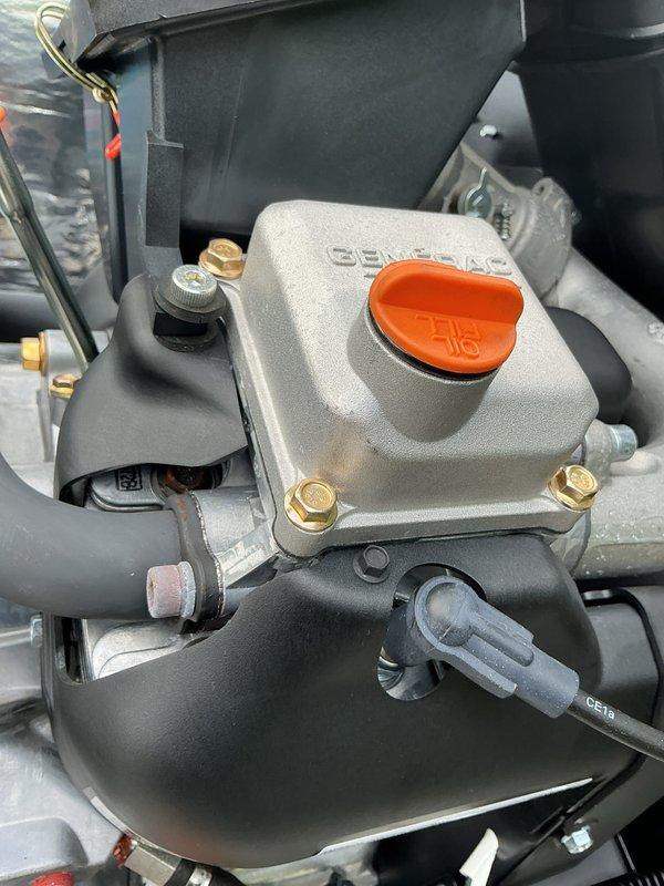Performed scheduled maintenance tune-up on a Generac 24kW standby generator as part of a recurring service plan. Inspected the engine, valve cover, spark plug area, hoses, oil filter, control panel, and enclosure insulation, finding all components clean and in good condition with no visible rust, cracks, or damage. The unit was also enrolled in the recurring generator maintenance program for continued scheduled service.