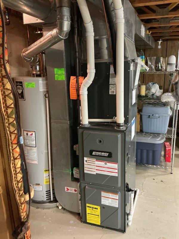 Performed annual heating inspection and maintenance on a 14-year-old Energi Air gas furnace, including visual inspection of the heat exchanger and internal ductwork using a digital inspection camera. Camera imagery showed light surface rust and condensation or frost in the interior, while the furnace, venting, and adjacent water heater exhibited no leaks or visible damage. System operation was verified, with no humidifier present.