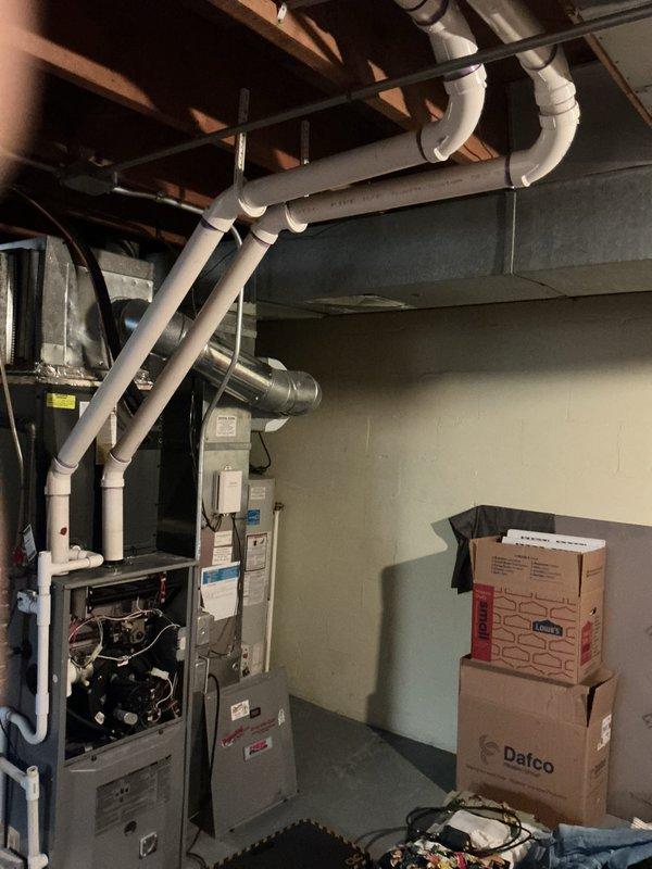 Performed a rental inspection on one gas furnace and one gas water heater, with the furnace access panel removed to visually assess the burners, wiring, blower motor, and control components. Inspected the PVC vent piping, flexible and rigid ductwork, plenum connections, and water heater piping, and found no visible frost, rust, or cracking. Documented equipment condition with photos and noted clutter around the mechanical area.
