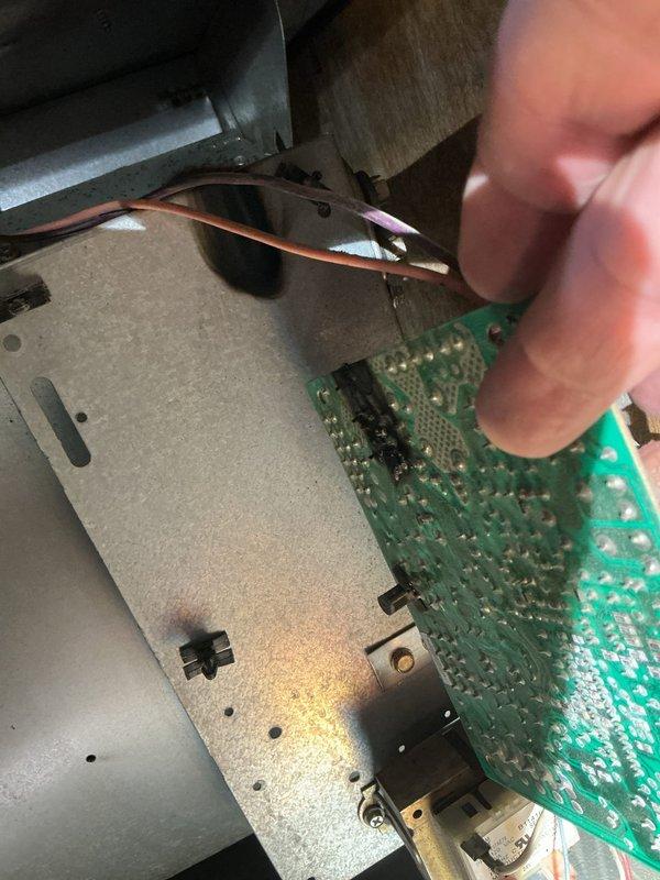 Removed and replaced two existing air conditioning units, installing new equipment and verifying proper operation. During the changeout, a scorched control circuit board with visible burn damage at the solder joints was identified and removed from the air handler cabinet. Outdoor condenser pad area was cleared and the units were set in place.