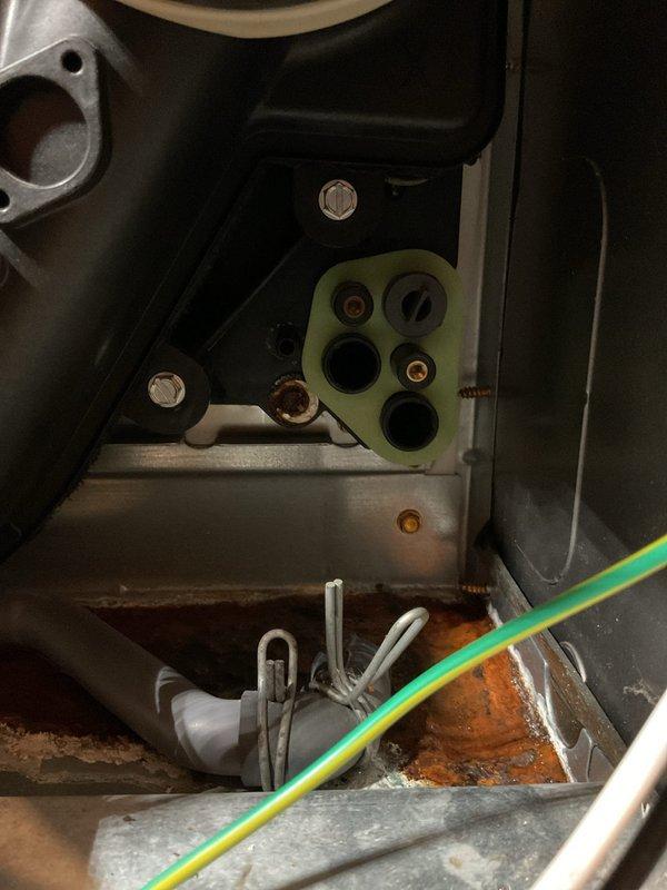 Performed annual furnace and humidifier tune-up, inspecting the humidifier housing, drain hose, and clamped connections within the cabinet. Documented heavy rust and corrosion on fasteners, the humidifier plate fittings, and the cabinet base pan, along with mineral residue and staining indicating prior moisture or leakage. Recommend monitoring the condensate and humidifier drain lines and addressing the source of moisture to prevent further corrosion.