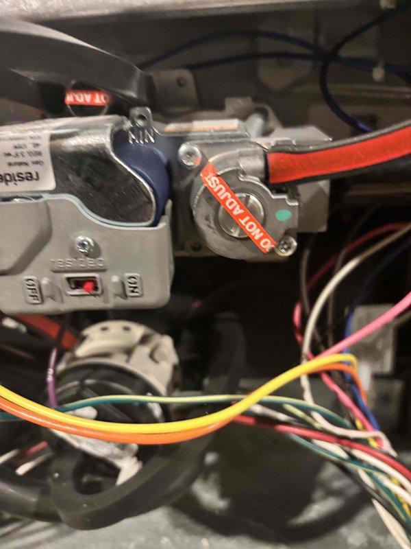 Performed annual furnace tune-up and inspection, including evaluation of the gas control valve assembly, wiring, and pressure switch components, with the gas valve adjustment cap confirmed factory-sealed with "DO NOT ADJUST" labeling. Inspected the return air filter and found heavy lint and debris loading across the pleated media, indicating the filter requires replacement to maintain proper airflow and heating efficiency.
