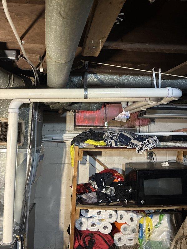 Installed a new Energi Elite Series vertical gas furnace in the basement mechanical area, connecting it to the existing supply plenum and ductwork. Completed PVC condensate drain and combustion venting, copper gas line with shutoff valve, and electrical connections, and set the unit on a drip pan. The installation is complete with no visible leaks or damage.