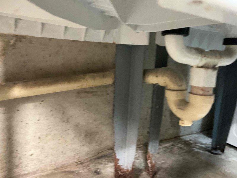 Diagnosed a leak at the washing machine drain, identified a cracked drain pipe allowing water to escape into the washer tub area following a recent shutoff valve replacement. Inspected the drain line and P-trap assembly beneath the utility basin, then repaired the cracked section and secured the connections to restore a watertight drain. Tested the system under load to confirm the leak was resolved.