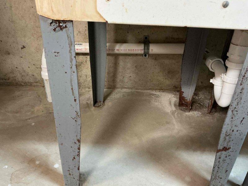 Diagnosed a leak at the washing machine drain, identified a cracked drain pipe allowing water to escape into the washer tub area following a recent shutoff valve replacement. Inspected the drain line and P-trap assembly beneath the utility basin, then repaired the cracked section and secured the connections to restore a watertight drain. Tested the system under load to confirm the leak was resolved.