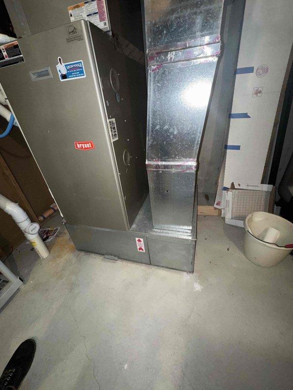 Conducted an on-site furnace replacement estimate for a 14-year-old Bryant gas furnace with an existing whole-home humidifier installed in a basement utility area. Inspected the furnace cabinet, supply plenum and trunk ductwork, refrigerant line set, PVC condensate drain, gas supply line, and surrounding clearances, documenting equipment data plates and existing system configuration with photos. No visible rust, frost, or ductwork damage was observed, and the existing duct seams were found sealed with foil tape and mastic.