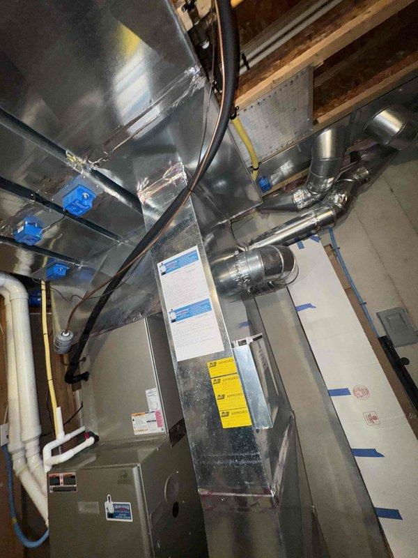 Conducted an on-site furnace replacement estimate for a 14-year-old Bryant gas furnace with an existing whole-home humidifier installed in a basement utility area. Inspected the furnace cabinet, supply plenum and trunk ductwork, refrigerant line set, PVC condensate drain, gas supply line, and surrounding clearances, documenting equipment data plates and existing system configuration with photos. No visible rust, frost, or ductwork damage was observed, and the existing duct seams were found sealed with foil tape and mastic.