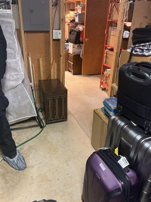 Responded to a no-hot-water complaint on a 10-year-old Bradford White tank water heater in the basement, accessing the unit through a congested storage area. Photos documented the surrounding conditions, including damp, discolored concrete floor patches and staining on the overhead OSB deck near the water and venting lines. Specific diagnostic findings and repair actions were not recorded in the available details, so the cause of the no-heat condition and any corrective work should be confirmed with the technician before this entry is finalized.